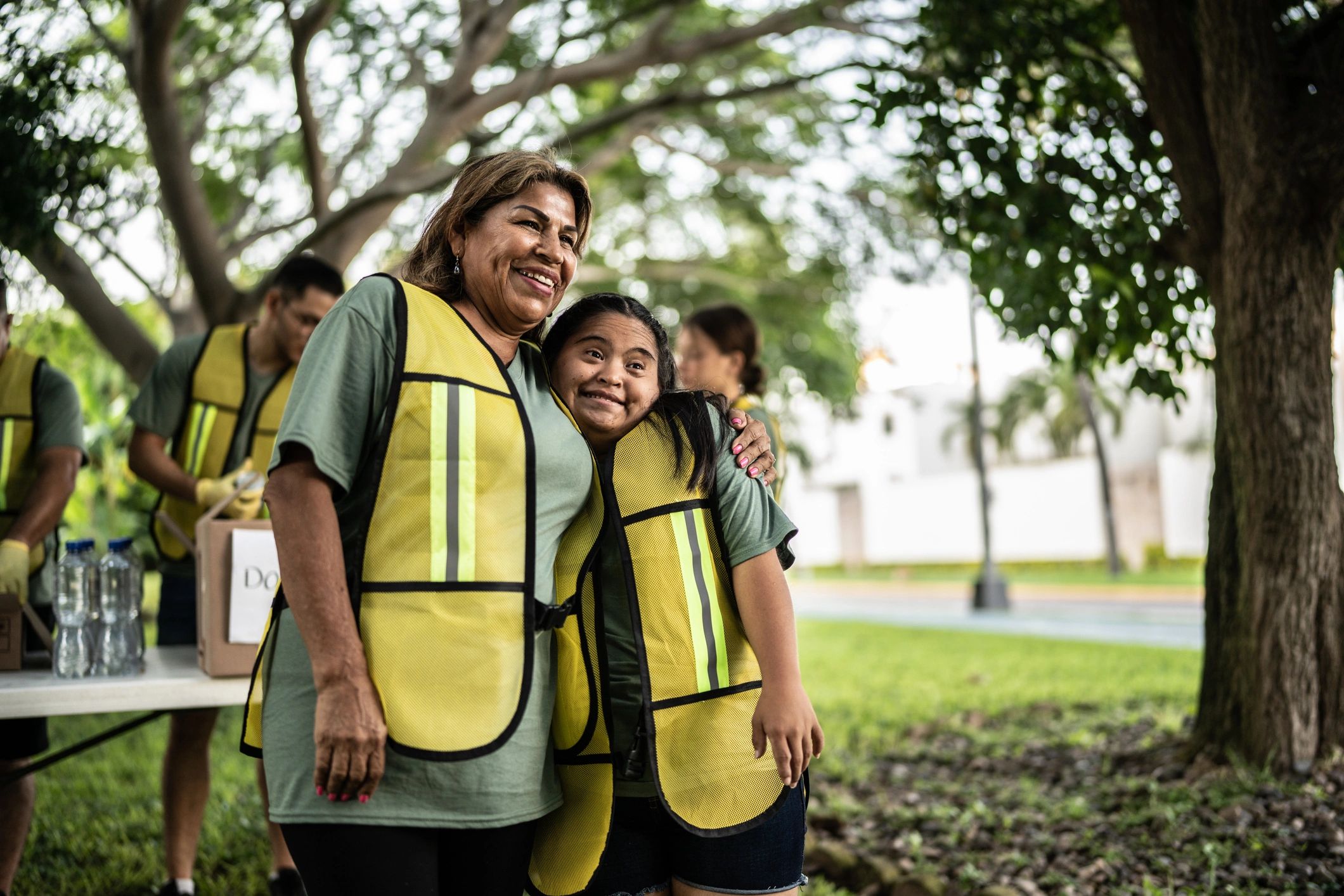 Mother and daughter volunteering together in a park