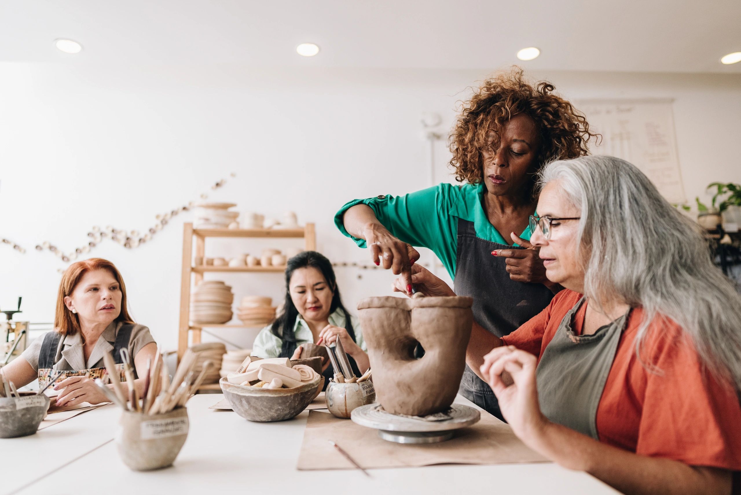Woman teaching another woman in a workshop