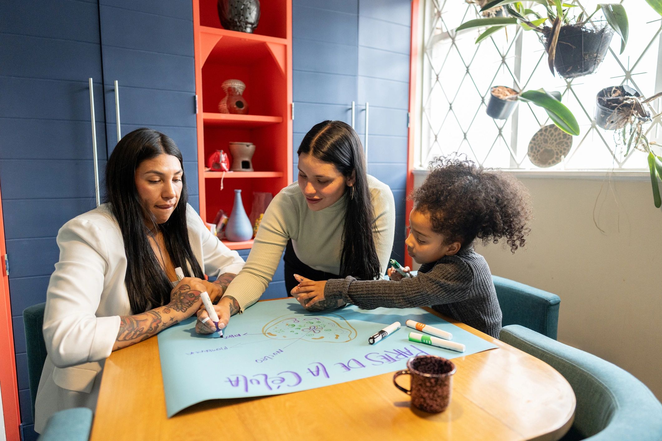 Mothers and daughter drawing together at home